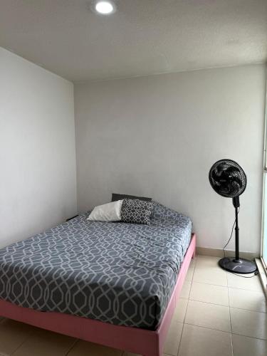 a bedroom with a bed and a fan in it at Apartamento para 4 personas CDMX in Mexico City