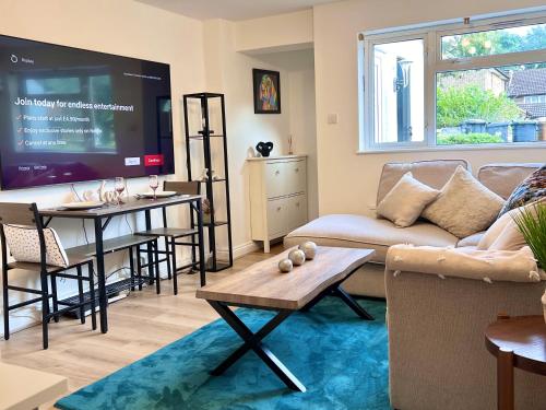 a living room with a couch and a tv at Bibis Home - Hertford in Hertford