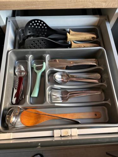a tray filled with utensils in a drawer at Mirvana Apartments Legacy Residence in Timişoara