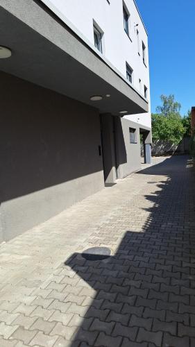 a shadow of a building on a brick sidewalk at Mirvana Apartments Legacy Residence in Timişoara