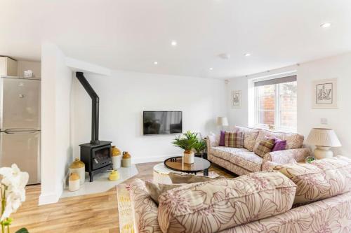 a living room with a couch and a fireplace at Braeburn Cottage Central Bewdley- 2 Parking Spaces in Bewdley