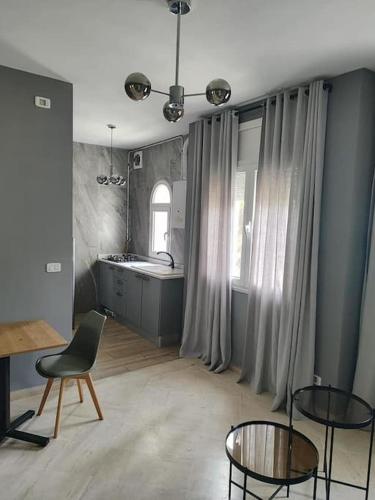 a room with a kitchen with a table and chairs at la Soukra in La Soukra