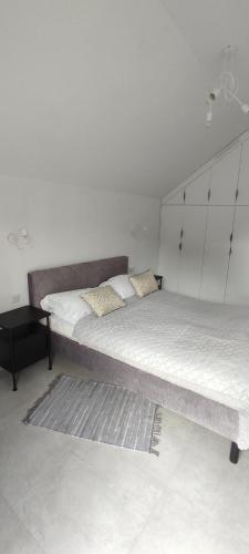 a bedroom with a large bed with a headboard at Nowa Osada in Łącko