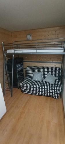 a room with a bunk bed and a wooden floor at Ax 3 domaines in Ax-les-Thermes