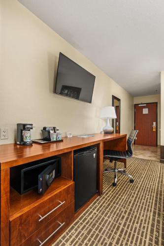 a desk with a television and a chair in a room at Ellis Island Hotel Casino & Brewery in Las Vegas