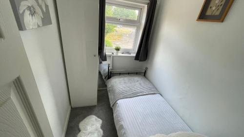 a small room with a bed and a window at Single Room Near Basildon City Centre in Basildon