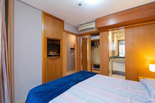 a bedroom with a large bed and a bathroom at LFlats no Hotel Stella Vega (EX-Mercury Ibirapuera) in Sao Paulo