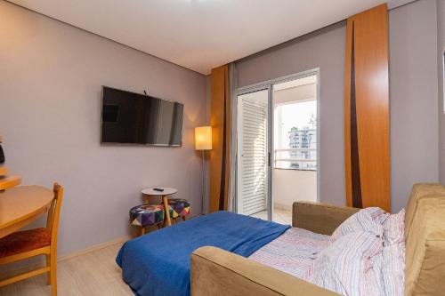a living room with a bed and a tv at LFlats no Hotel Stella Vega (EX-Mercury Ibirapuera) in Sao Paulo