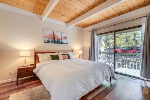 a bedroom with a bed and a large window at 5 Mi to Northstar Bear Den Home with Decks! in Kings Beach