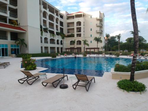 a swimming pool in front of a building at 403 Landmark Resort Cozumel beachfront condo in Cozumel