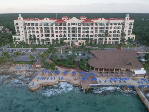 an aerial view of a resort with a swimming pool at 403 Landmark Resort Cozumel beachfront condo in Cozumel