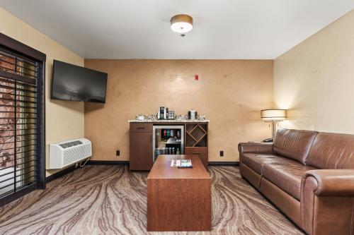 a living room with a couch and a tv at Ellis Island Hotel Casino & Brewery in Las Vegas