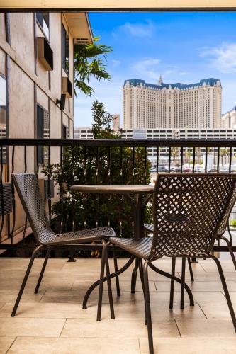 a patio with two chairs and a table on a balcony at Ellis Island Hotel Casino & Brewery in Las Vegas