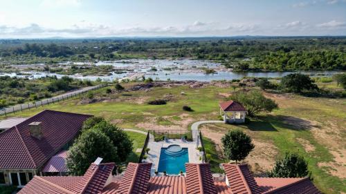 an aerial view of a house with a swimming pool at Bliss On The River in Llano