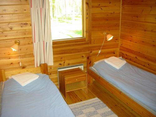 Postel nebo postele na pokoji v ubytování Ukonjärven Holiday Village