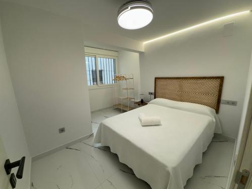 ein weißes Schlafzimmer mit einem Bett mit einer weißen Decke in der Unterkunft Boabdil Luxury home in Córdoba