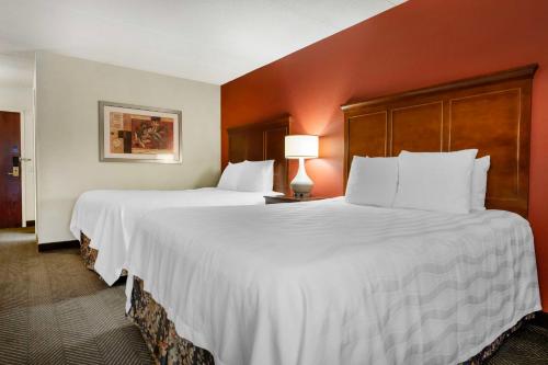 a large white bed in a hotel room at Best Western Plus St. Paul North/Shoreview in Shoreview