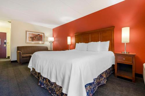 a hotel room with a large bed and a chair at Best Western Plus St. Paul North/Shoreview in Shoreview