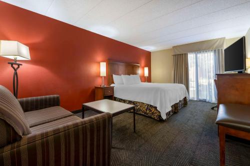 a hotel room with a bed and a couch at Best Western Plus St. Paul North/Shoreview in Shoreview