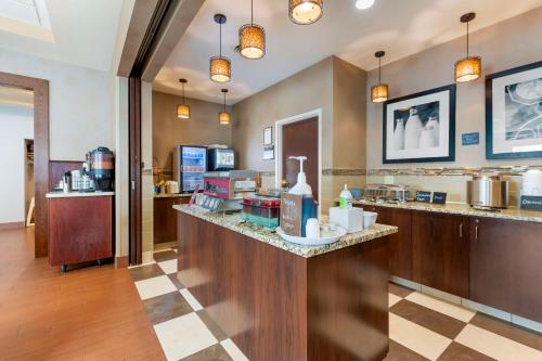 a restaurant with a counter with a food at Best Western Plus St. Paul North/Shoreview in Shoreview