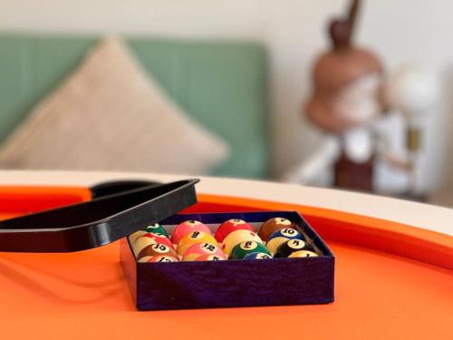 a box of angry birds dominoes on an orange table at Fairyland Getaway- at Central Coast with XXXL hot Jacuzzi & Fun - Round pool table and Slide bunk bed in Narara
