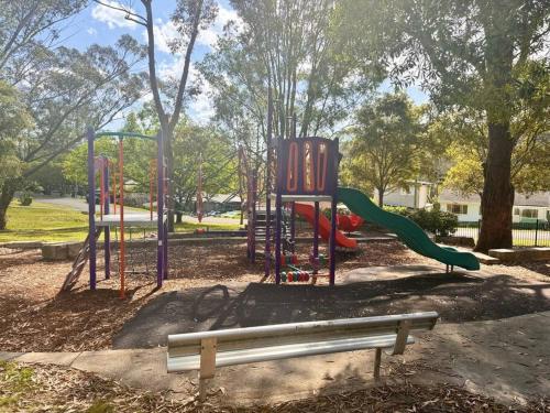 a park with a playground with a slide at Fairyland Getaway- at Central Coast with XXXL hot Jacuzzi & Fun - Round pool table and Slide bunk bed in Narara