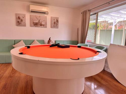 a large circular table in a room with a couch at Fairyland Getaway- at Central Coast with XXXL hot Jacuzzi & Fun - Round pool table and Slide bunk bed in Narara
