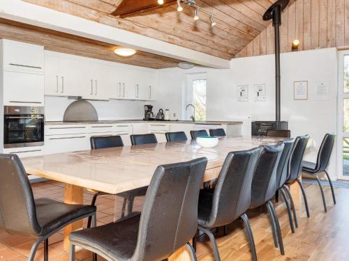 a large kitchen with a wooden table and chairs at Scenic Pool House Retreat - By Traum Ferienwohnungen in Thyholm