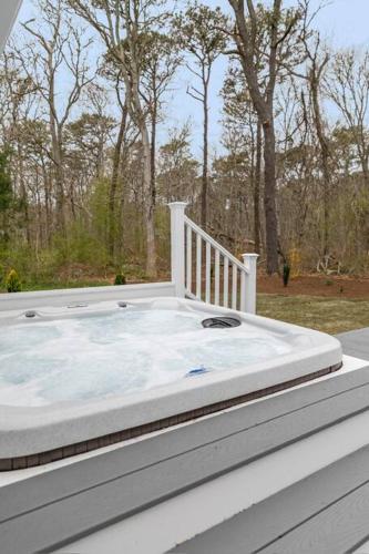 a hot tub sitting on top of a house at Retreat by the Hot Tub & Fire Pit, Dog-Friendly! in Brewster