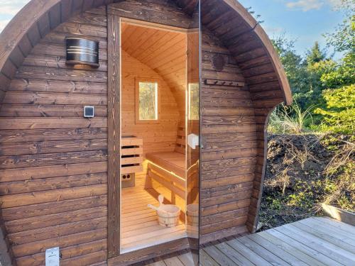 a wooden sauna with a large arched doorway at 5 star holiday home in Vestervig-By Traum in Vestervig