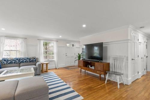 a living room with a couch and a tv at Retreat by the Hot Tub & Fire Pit, Dog-Friendly! in Brewster