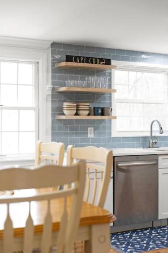 a kitchen with a table and chairs and a sink at Retreat by the Hot Tub & Fire Pit, Dog-Friendly! in Brewster