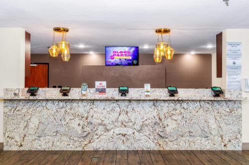 a lobby with a large marble counter with chandeliers at Ellis Island Hotel Casino & Brewery in Las Vegas