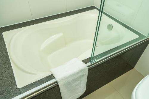 a bathtub with a towel on it in a bathroom at Antawa Hotel in Moquegua
