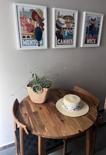 a wooden table with a hat on top of it at Ideal studio near Monaco in Roquebrune-Cap-Martin