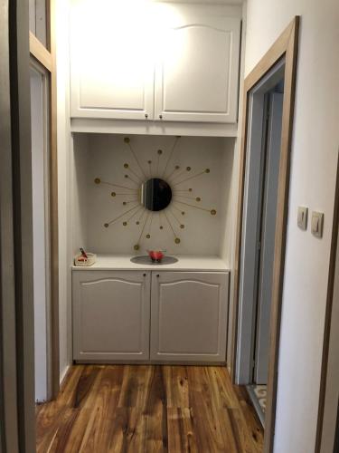 a clock on the wall of a hallway with a floor at Gavriel Boutique Residence Wellness Spa in Szada