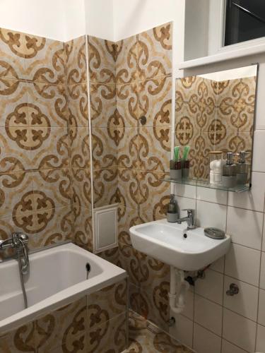a bathroom with a sink and a bath tub at Gavriel Boutique Residence Wellness Spa in Szada