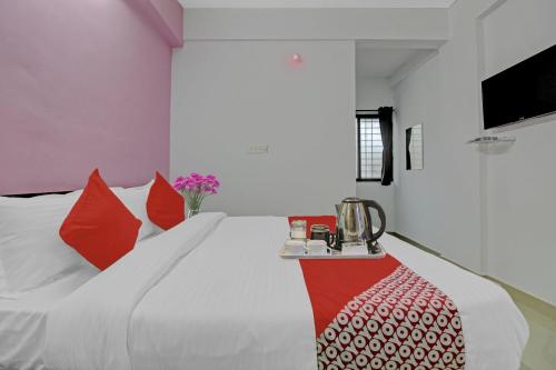 Ένα ή περισσότερα κρεβάτια σε δωμάτιο στο Hotel O Happy Stay