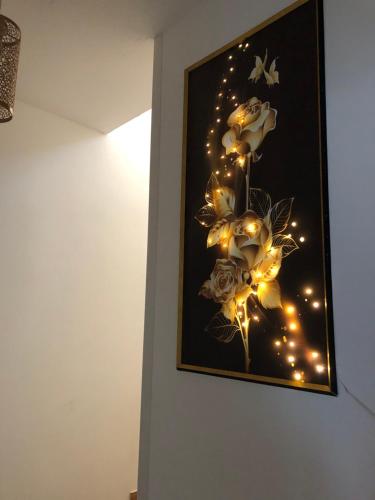 a painting of flowers with lights on a wall at Gavriel Boutique Residence Wellness Spa in Szada