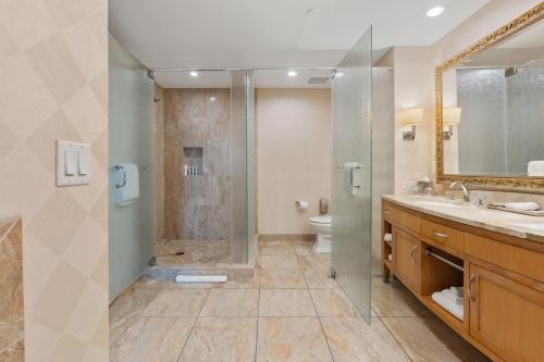 a bathroom with a shower and a toilet and a sink at TRUMP 56th Floor - Sphere and Strip View - No Resort Fees in Las Vegas