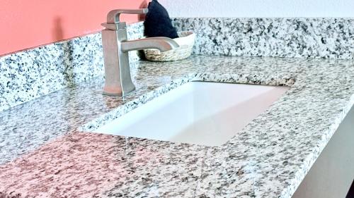 a white sink in a counter with a faucet at City Center Motel in Medford