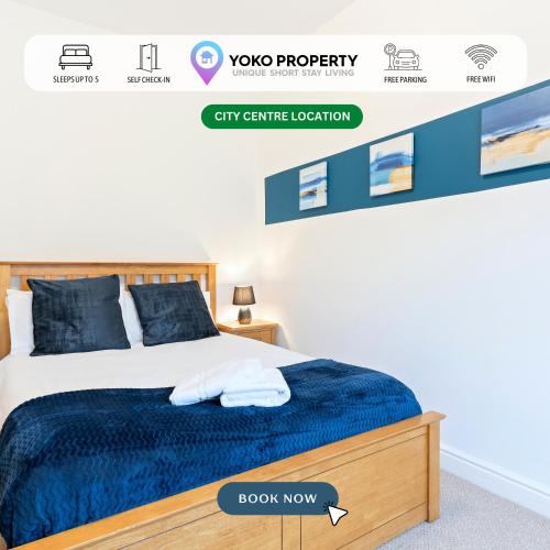 a bedroom with a bed with a blue comforter at Elton House - Prime Location - Free Parking, Fast WiFi and Smart TV by Yoko Property in Redcar