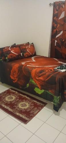 a bed in a room with two rugs on the floor at Mack's Home in Clifton