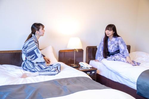 Postel nebo postele na pokoji v ubytování Yufuin Hotel Shuhokan