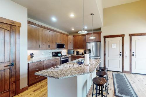 a kitchen with wooden cabinets and a granite counter top at Bears Den Condo Unit 1 in Frisco
