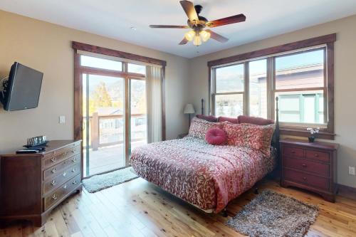 a bedroom with a bed and a ceiling fan at Bears Den Condo Unit 1 in Frisco