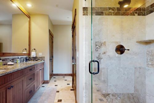 a bathroom with a shower with a glass door at Bears Den Condo Unit 1 in Frisco