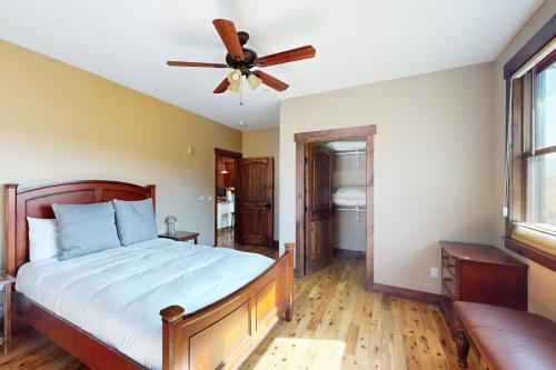 a bedroom with a bed and a ceiling fan at Bears Den Condo Unit 1 in Frisco