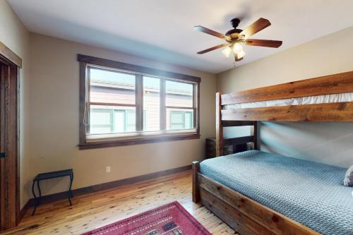 a bedroom with a bunk bed and a ceiling fan at Bears Den Condo Unit 1 in Frisco