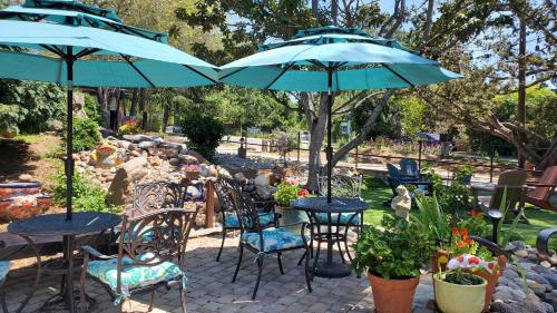 a patio with tables and chairs with umbrellas at Carmel Valley Lodge in Carmel Valley